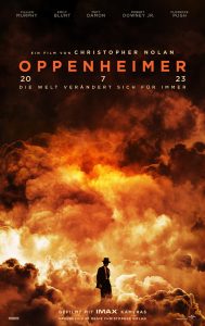 Man sieht Oppenheimer vor einer gewaltigen Atomwolke bzw. Explosion stehen.